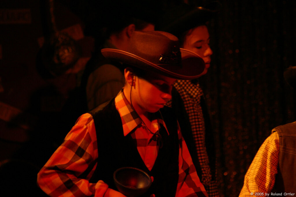 Bastian stands in the circus ring as a young diabolo beginner and prepares his diabolo to play.